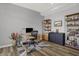 Home office featuring wood floors, gray walls, a modern desk, and custom shelving at 5492 Cottage Grove Ln, Noblesville, IN 46062