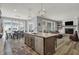Kitchen island with stainless steel dishwasher overlooking breakfast nook and fireplace at 5492 Cottage Grove Ln, Noblesville, IN 46062