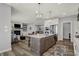 Open concept: Kitchen with island opens to living room with fireplace; great for entertaining at 5492 Cottage Grove Ln, Noblesville, IN 46062
