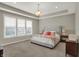 A main bedroom with a tray ceiling, neutral walls, and plush carpet at 5492 Cottage Grove Ln, Noblesville, IN 46062