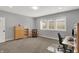 Spacious home office featuring a chair, desk, cabinets, and three windows, offering a well-lit workspace at 5492 Cottage Grove Ln, Noblesville, IN 46062
