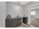 Charming wet bar area with a sink, gray countertops, and decorative lighting fixtures at 5492 Cottage Grove Ln, Noblesville, IN 46062