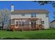 Exterior of home showcases a spacious backyard and wood deck with decorative lattice at 5639 Aquamarine Dr, Carmel, IN 46033