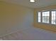 Sunlit bedroom with large windows offering serene outdoor views, soft carpeting, and ample natural light at 5639 Aquamarine Dr, Carmel, IN 46033