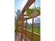 Wooden deck with pergola adorned with hanging flower baskets, creating a cozy outdoor space at 5639 Aquamarine Dr, Carmel, IN 46033