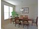 Bright dining room with a large window, a plant, and a wooden table at 5639 Aquamarine Dr, Carmel, IN 46033