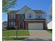 Charming two-story brick home with a well-manicured lawn and a two-car garage at 5639 Aquamarine Dr, Carmel, IN 46033
