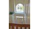 Elegant foyer with a large arched window overlooking lush landscaping and a charming front entrance, creating a warm welcome at 5639 Aquamarine Dr, Carmel, IN 46033