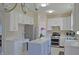 Bright kitchen featuring white cabinets, stainless steel appliances, and a functional center island at 5639 Aquamarine Dr, Carmel, IN 46033