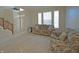 Comfortable living room featuring plush seating, neutral carpeting, and bright natural light at 5639 Aquamarine Dr, Carmel, IN 46033
