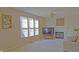Bright living room features a fireplace, neutral carpet, and plenty of natural light from a large window at 5639 Aquamarine Dr, Carmel, IN 46033