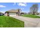 Attractive brick home with manicured lawn, an American flag, and a two-car garage at 5766 Kensington S Way, Plainfield, IN 46168