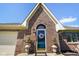 A beautiful brick home with a blue front door, decorative wreath, and manicured landscaping at 5766 Kensington S Way, Plainfield, IN 46168