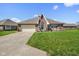 Charming brick home with a well-manicured lawn, American flag, and inviting curb appeal at 5766 Kensington S Way, Plainfield, IN 46168