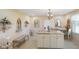 Eat-in kitchen shows center island with seating, neutral walls, tile floors and decorative accents at 5766 Kensington S Way, Plainfield, IN 46168