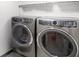 The well-equipped laundry room features modern front load washer and dryer units at 5766 Kensington S Way, Plainfield, IN 46168