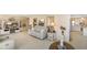 A comfy living room features a neutral palette, tile floors and opens to the kitchen at 5766 Kensington S Way, Plainfield, IN 46168