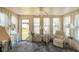 Sunroom with light walls, carpet flooring, ceiling fan, and white curtains at 5766 Kensington S Way, Plainfield, IN 46168
