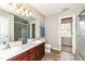 Spacious bathroom with double vanity, tile flooring, and separate shower with glass door at 5856 Long Ridge Pl, Indianapolis, IN 46221