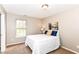 Neutral bedroom with carpet, a window, and a queen sized bed with decorative pillows at 5856 Long Ridge Pl, Indianapolis, IN 46221