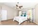 Comfortable bedroom features a ceiling fan, windows, and a soothing color palette at 5856 Long Ridge Pl, Indianapolis, IN 46221