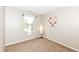 Carpeted bedroom with a window and decorated with sports themed wall art at 5856 Long Ridge Pl, Indianapolis, IN 46221