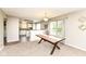 Bright dining room with modern table and view into the kitchen area at 5856 Long Ridge Pl, Indianapolis, IN 46221