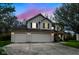 Two-story home with three-car garage, siding, and black shutters against a beautiful colorful sky at 5856 Long Ridge Pl, Indianapolis, IN 46221