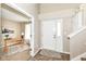 Bright foyer with tile flooring, coat closet, and doorway leading to a versatile room at 5856 Long Ridge Pl, Indianapolis, IN 46221