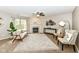 Bright living room featuring a fireplace, mantel, carpet flooring, comfortable seating, and neutral tones at 5856 Long Ridge Pl, Indianapolis, IN 46221