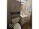 Small bathroom featuring a toilet, vanity, mirror, and storage at 5868 Hillside Ave, Indianapolis, IN 46220