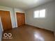 Modest bedroom with wood floors, light walls, and closet space at 5868 Hillside Ave, Indianapolis, IN 46220