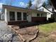 Charming single story home with white siding, brick foundation, and mature trees in a suburban setting at 5868 Hillside Ave, Indianapolis, IN 46220