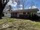 Well-maintained single-story home featuring vinyl siding, a brick facade, and a lush front lawn at 5868 Hillside Ave, Indianapolis, IN 46220