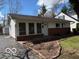 Charming single story home with white siding, brick foundation, and mature trees in a suburban setting at 5868 Hillside Ave, Indianapolis, IN 46220