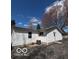 Rear view of a house with white siding, a small window, and a back patio at 5868 Hillside Ave, Indianapolis, IN 46220