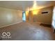 Spacious living room with neutral carpet and view of an adjacent room at 5868 Hillside Ave, Indianapolis, IN 46220