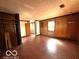 Living room with brick floor and wood paneling at 5868 Hillside Ave, Indianapolis, IN 46220