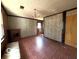 Living room with brick floor, wood paneling and a fireplace at 5868 Hillside Ave, Indianapolis, IN 46220
