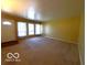 Bright living room featuring carpet, large windows, and a neutral color palette at 5868 Hillside Ave, Indianapolis, IN 46220