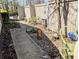 View of the back yard with privacy fence, garden area, and lawn decorations at 61 Osage Ct, Columbus, IN 47201