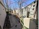 View of the back yard with privacy fence, garden area, and lawn decorations at 61 Osage Ct, Columbus, IN 47201