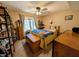 Bedroom with a window, ceiling fan, shelf display, and furniture at 61 Osage Ct, Columbus, IN 47201