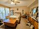 Bedroom with an outdoor view, recliner, complimented by a dresser with mirror at 61 Osage Ct, Columbus, IN 47201