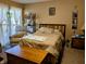 Bedroom with a recliner, an outdoor view, complimented by a comfortable bed at 61 Osage Ct, Columbus, IN 47201
