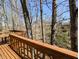 An expansive wood deck providing ample space for outdoor seating and relaxation, surrounded by woods at 61 Osage Ct, Columbus, IN 47201