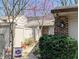 View of home entrance with walkway and garden, enhanced by privacy fence and flowering tree at 61 Osage Ct, Columbus, IN 47201