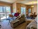 Open living room with sliding door access to deck, dining area, and comfortable sofa set at 61 Osage Ct, Columbus, IN 47201