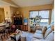 Living room features natural light, neutral color, sofa, and a partial view to kitchen bar seating at 61 Osage Ct, Columbus, IN 47201