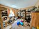 Living room with shelves displaying books, complimented by a large window and cat tree at 61 Osage Ct, Columbus, IN 47201